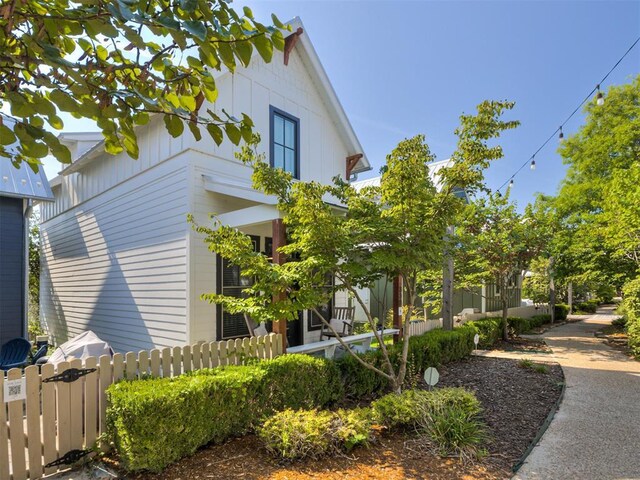 view of side of home with fence