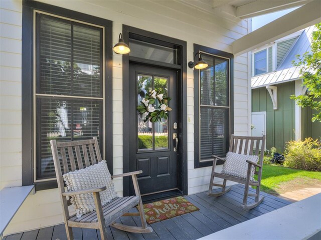 view of exterior entry with a porch