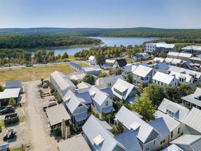 bird's eye view with a water view and a forest view