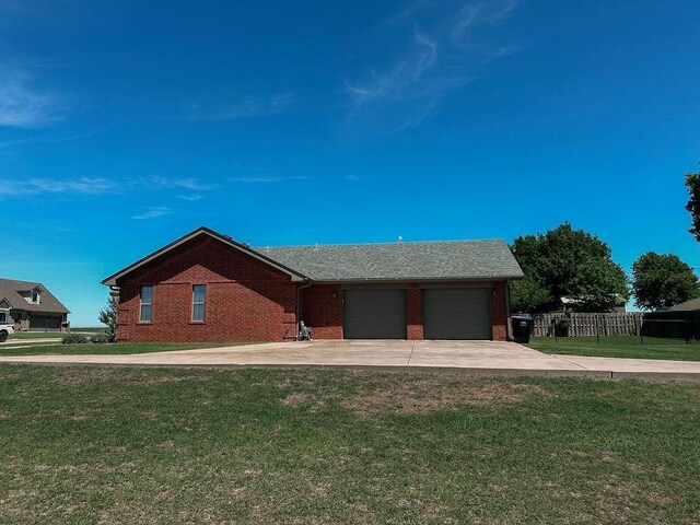 view of front of property with brick siding, a garage, a front yard, and concrete driveway