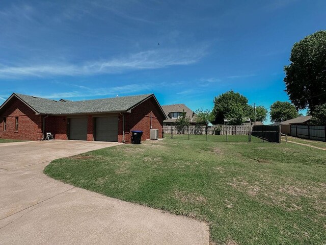 exterior space with fence, an attached garage, and concrete driveway