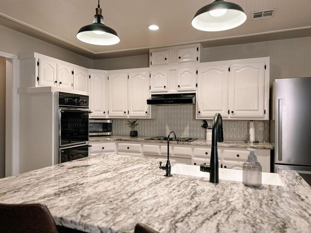 kitchen with tasteful backsplash, black appliances, white cabinetry, and visible vents