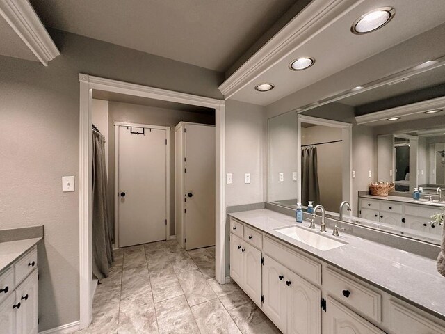 bathroom featuring recessed lighting, marble finish floor, and vanity