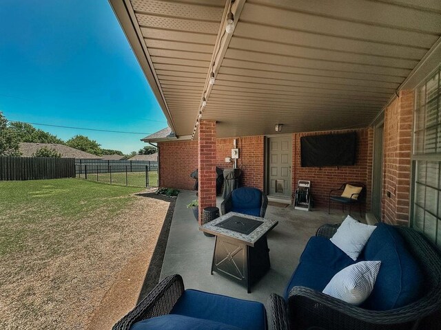 view of patio with an outdoor fire pit and fence
