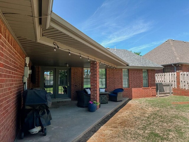 view of patio featuring grilling area and fence