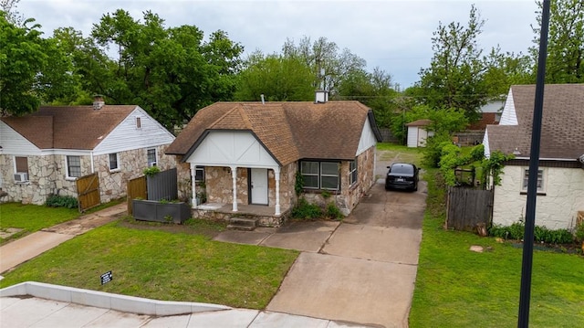 624 SW 44th St, Oklahoma City, OK 73109 - bungalow-style house with a front lawn, fence, driveway, and stone siding