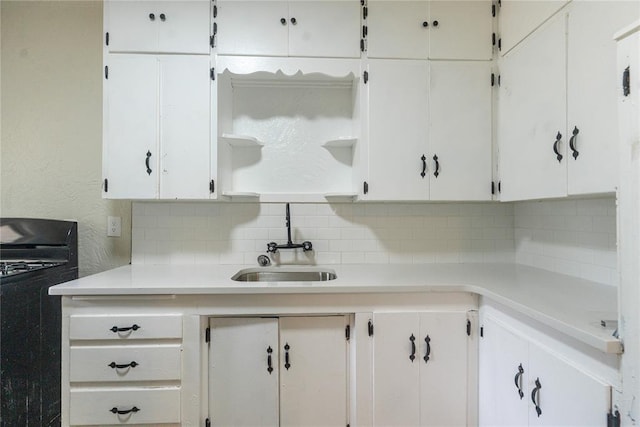 624 SW 44th St, Oklahoma City, OK 73109 - kitchen with a sink, light countertops, tasteful backsplash, and black gas range