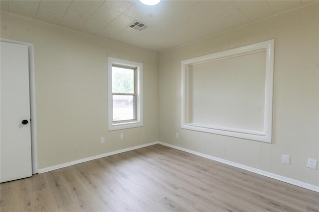 624 SW 44th St, Oklahoma City, OK 73109 - unfurnished room featuring baseboards, visible vents, and wood finished floors