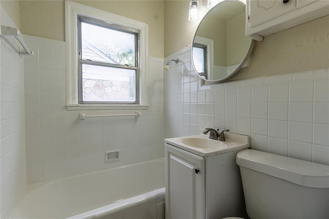 624 SW 44th St, Oklahoma City, OK 73109 - bathroom featuring vanity, a textured wall, toilet, tile walls, and shower / bath combination