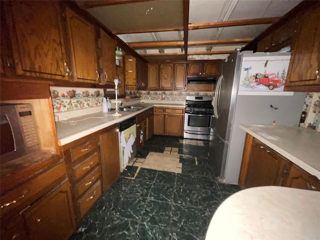 kitchen featuring stainless steel range with gas cooktop, dishwasher, under cabinet range hood, and light countertops