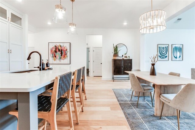 dining space featuring recessed lighting, light wood-type flooring, and visible vents