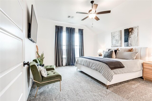 carpeted bedroom featuring visible vents, a ceiling fan, and lofted ceiling