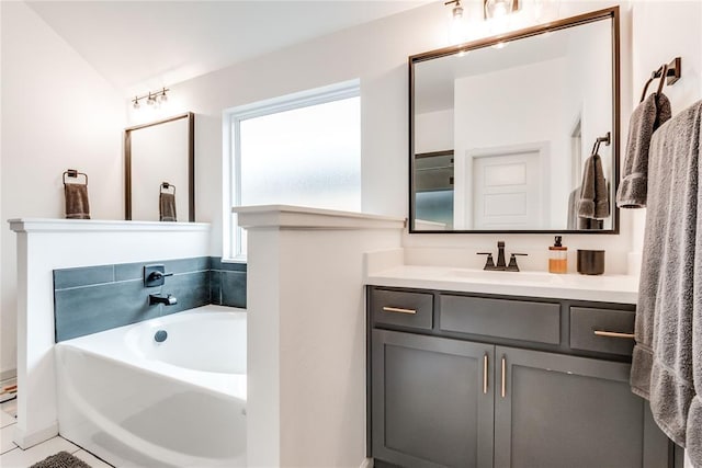 bathroom with a garden tub and vanity