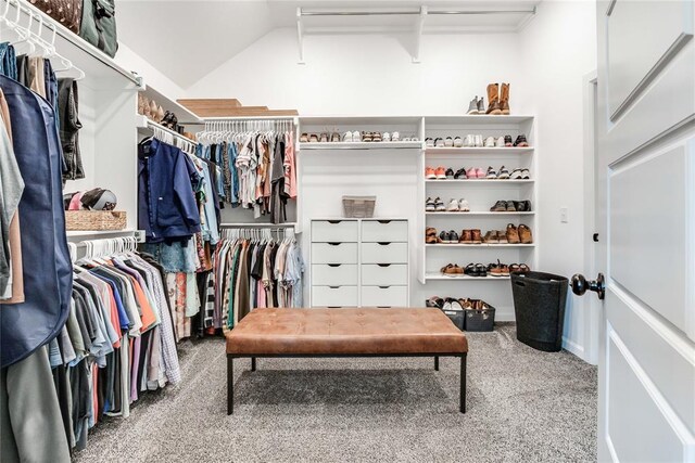walk in closet with carpet flooring and vaulted ceiling