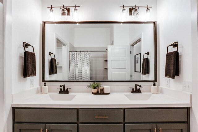 full bathroom featuring a sink, a shower with curtain, and double vanity