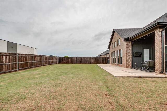 view of yard with a fenced backyard and a patio area