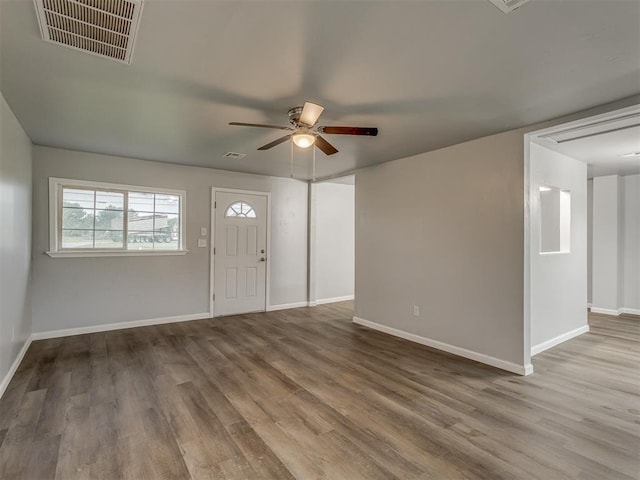 entryway with a ceiling fan, baseboards, visible vents, and wood finished floors