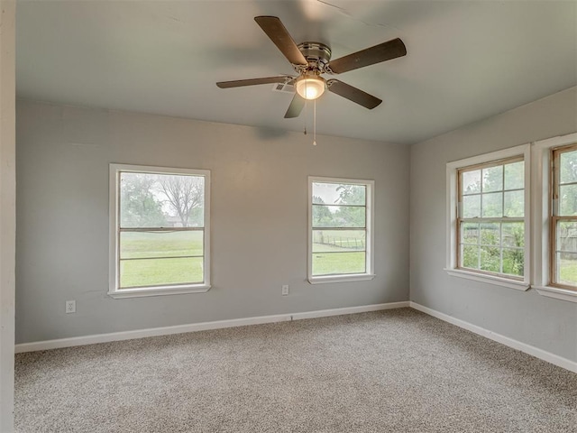 unfurnished room with baseboards, plenty of natural light, and carpet flooring