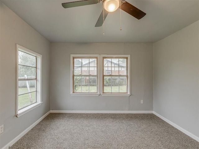 spare room featuring baseboards, carpet, and a ceiling fan