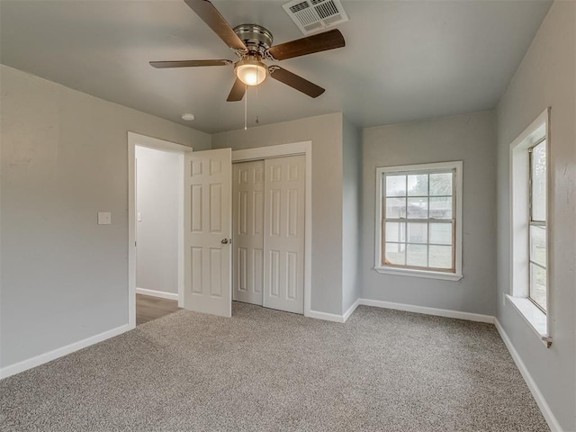 unfurnished bedroom with visible vents, carpet, baseboards, and a closet