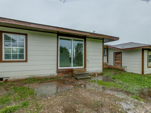 back of property featuring entry steps