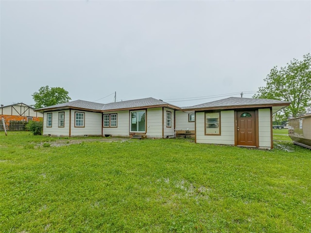 back of house with a yard, fence, and entry steps