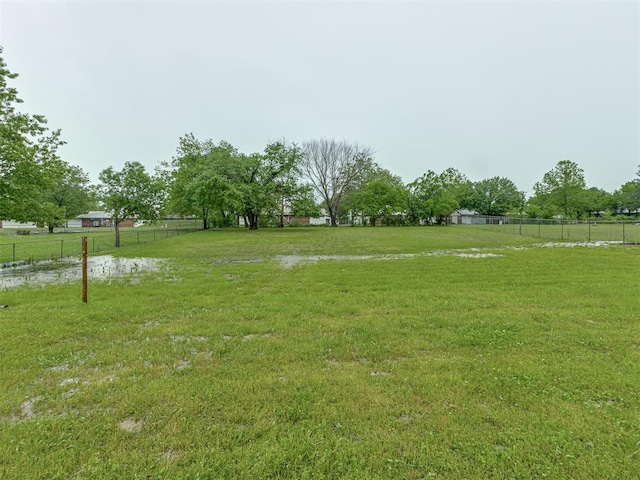 view of yard featuring fence and a rural view