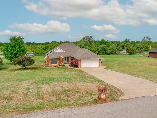 view of front of house featuring a front lawn, brick siding, a shingled roof, an attached garage, and driveway