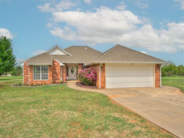 ranch-style house with a shingled roof, an attached garage, a front lawn, brick siding, and concrete driveway
