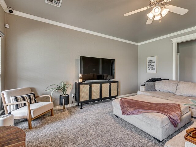 carpeted living room featuring crown molding, a ceiling fan, baseboards, and visible vents