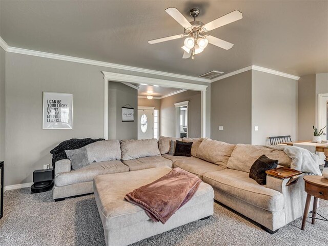 living room with ornamental molding, carpet, a ceiling fan, and visible vents