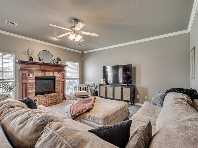 living room with carpet flooring, a ceiling fan, visible vents, and ornamental molding