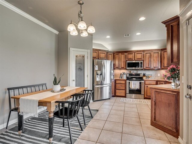 kitchen with backsplash, visible vents, light tile patterned floors, a chandelier, and stainless steel appliances