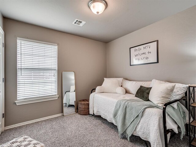 carpeted bedroom with baseboards and visible vents