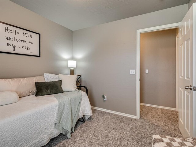 bedroom with baseboards and carpet flooring