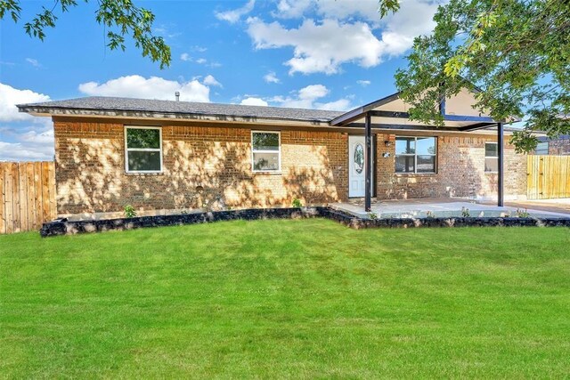 150 Bluestem St, Weatherford, OK 73096 - view of front of property featuring brick siding, fence, and a front lawn