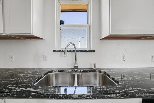 150 Bluestem St, Weatherford, OK 73096 - interior details with a sink, dark stone counters, and white cabinets