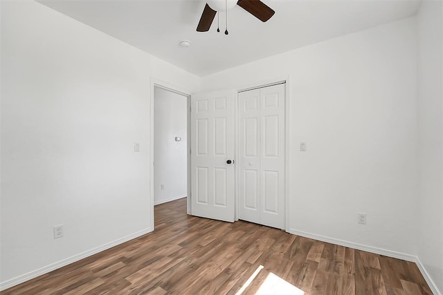 150 Bluestem St, Weatherford, OK 73096 - unfurnished bedroom featuring baseboards, ceiling fan, wood finished floors, and a closet