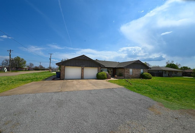 ranch-style house featuring brick siding, a garage, aphalt driveway, and a front yard
