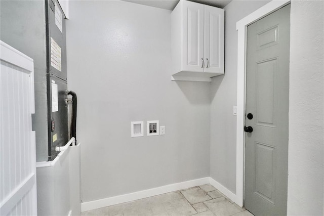 clothes washing area with cabinet space, hookup for a washing machine, and baseboards
