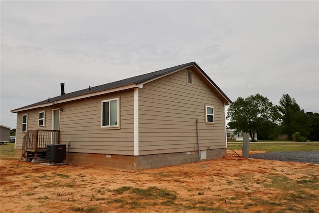 view of side of home with central AC unit and crawl space
