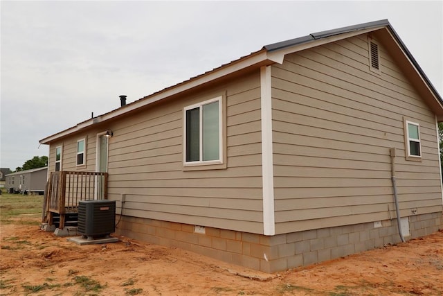 view of side of home featuring crawl space and cooling unit