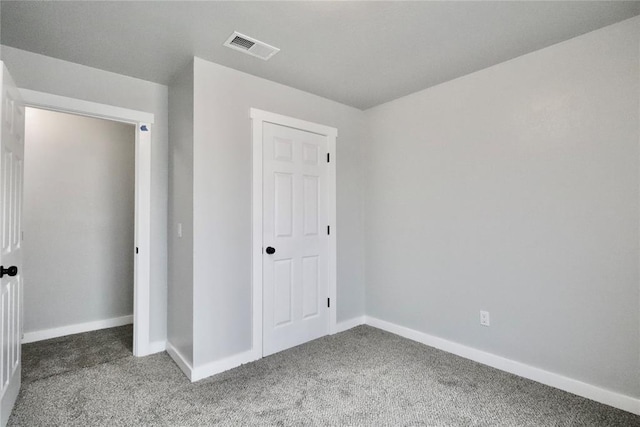 unfurnished bedroom featuring carpet flooring and baseboards