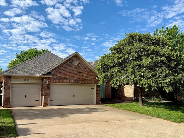 3900 Chickasha, Edmond, OK 73013 - view of front of property with brick siding, a garage, roof with shingles, and concrete driveway