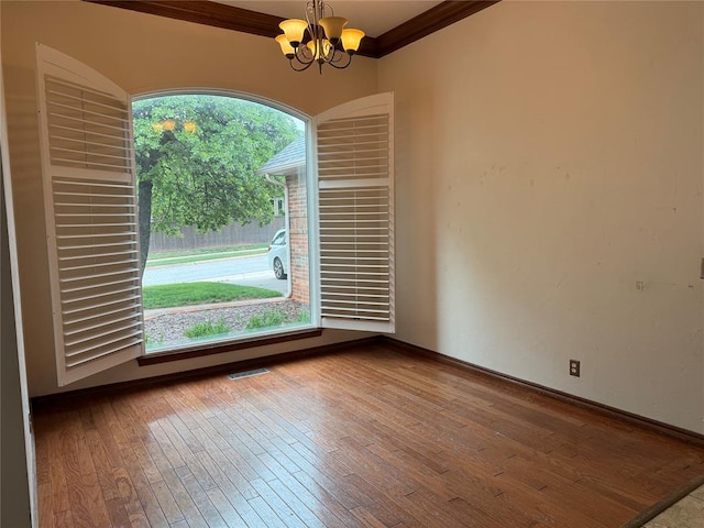 3900 Chickasha, Edmond, OK 73013 - empty room with an inviting chandelier, wood-type flooring, baseboards, visible vents, and ornamental molding