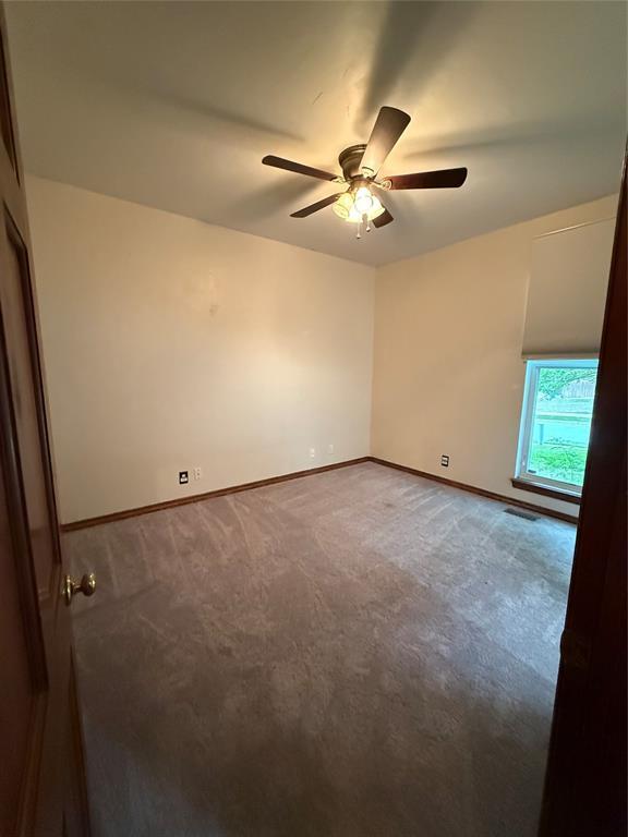 3900 Chickasha, Edmond, OK 73013 - carpeted spare room with baseboards, ceiling fan, and visible vents