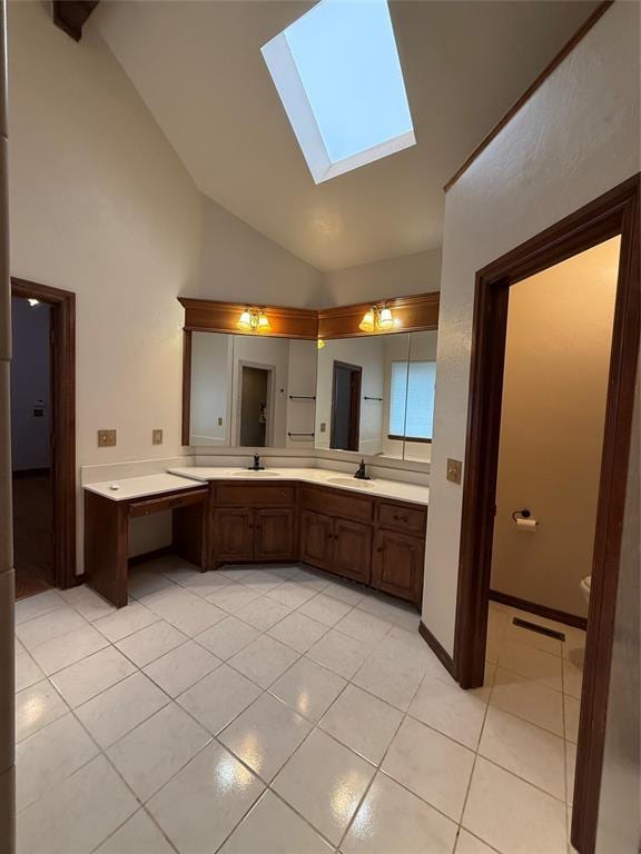 3900 Chickasha, Edmond, OK 73013 - full bathroom featuring tile patterned flooring, double vanity, high vaulted ceiling, a sink, and a skylight