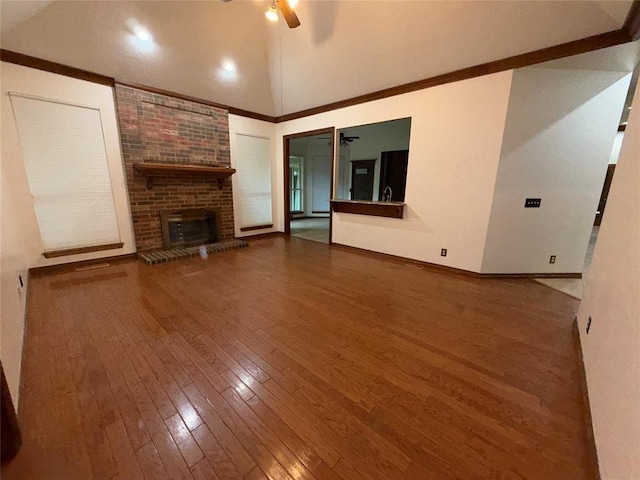 3900 Chickasha, Edmond, OK 73013 - unfurnished living room with a ceiling fan, a brick fireplace, baseboards, ornamental molding, and hardwood / wood-style floors