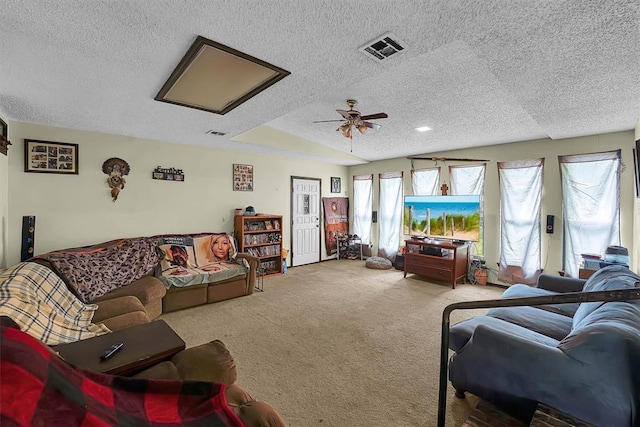 living area with visible vents, carpet flooring, a textured ceiling, and ceiling fan