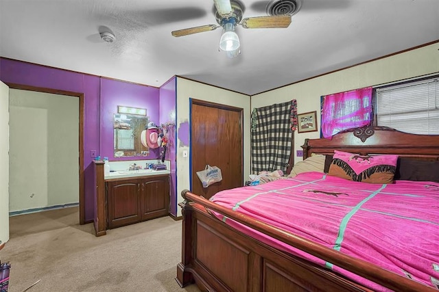 bedroom with a sink, visible vents, ceiling fan, and light colored carpet